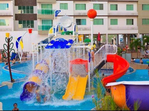 a pool with a water park with a slide at Riviera Park Hotel Luxo in Caldas Novas