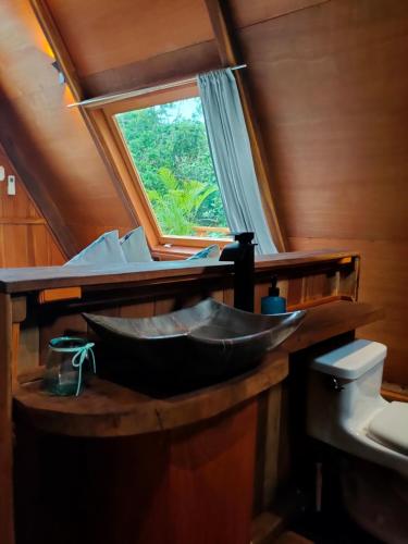 a bathroom with a sink and a window at El Búho Lagoon Bacalar in Bacalar
