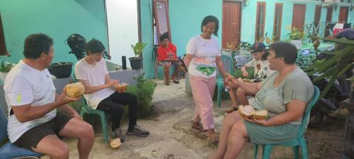 a group of people sitting around each other at Raja Ampat Sandy Guest House in Saonek
