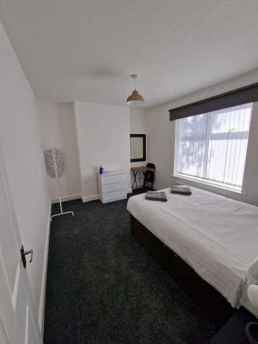 a bedroom with a large bed and a window at Luna Apartments Newcastle Gateshead 2 in Gateshead