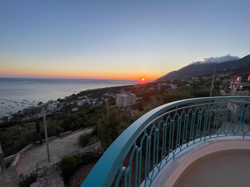 a view of the sunset from the balcony of a house at Endless blue Apartments in Dhërmi