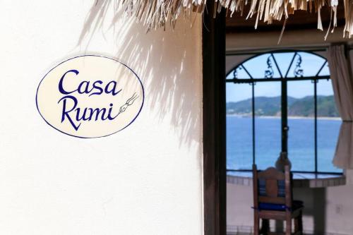 a sign on the side of a house with a window at Romantic Casa Rumi overlooking the Sea in Sayulita
