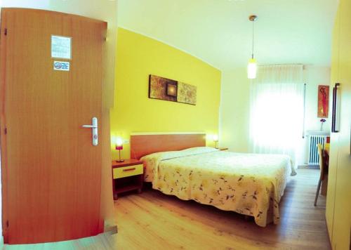 a hotel room with a bed and a window at Hotel Alpino in Malcesine