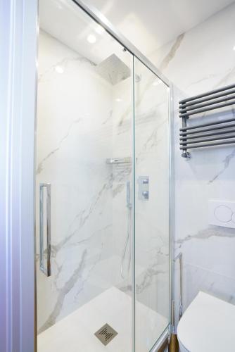 a glass shower in a bathroom with a toilet at Sotto Sale-5 Terre affittacamere in Riomaggiore