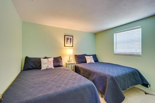 a bedroom with two beds and a window at New Port Richey Oasis with Private Pool! in New Port Richey