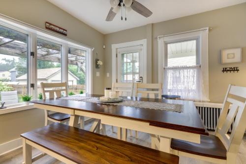 a dining room with a table and chairs and windows at 3 Mi to Dtwn Springfield Home with Deck! in Springfield
