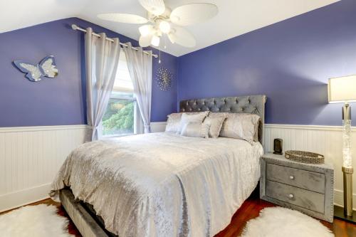 a purple bedroom with a bed and a window at 3 Mi to Dtwn Springfield Home with Deck! in Springfield