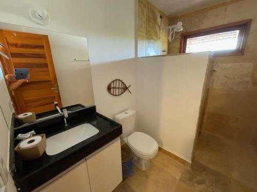 a bathroom with a sink and a toilet and a shower at BEACH HOUSE - Apartment 2 - com cozinha - with kitchen in Barra Grande