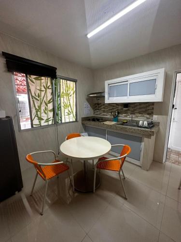 a kitchen with a table and chairs in a room at Depa los corales 3 in Mezcales