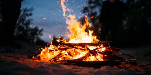 a fire is burning in the dirt at night at Lake Lauderdale Campground in Cambridge