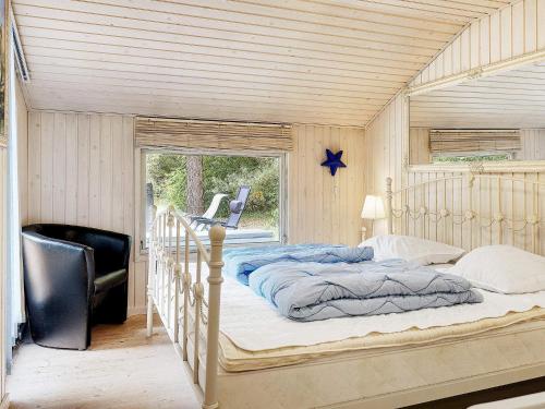 a bedroom with a bed with a wooden ceiling at Holiday home Jerup VII in Jerup