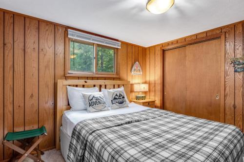 a bedroom with a bed in a wooden room at Equanimity in Eagle River