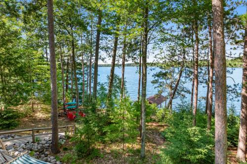 a view of a lake through the trees at Equanimity in Eagle River