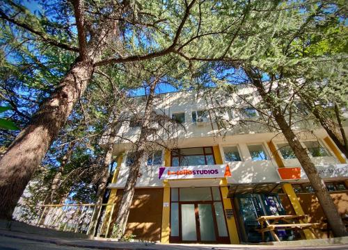 un bâtiment avec des arbres devant lui dans l'établissement Hello Studios Budget Stays Free Parking & Wifi, à Stara Zagora