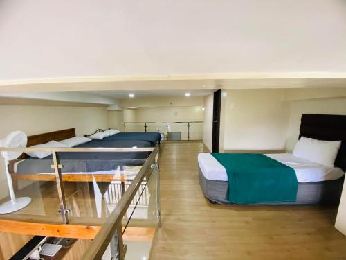 a room with two bunk beds on a boat at Evergreen Suites Baguio Condo Home Loft in Baguio