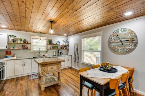 a kitchen with a table and a clock on the wall at Lindale Vacation Rental with Deck and Grill! in Lindale