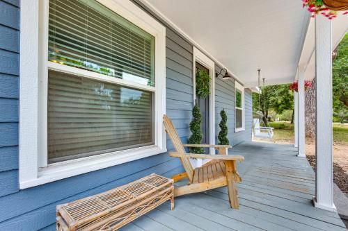 a wooden bench sitting on the front porch of a house at Lindale Vacation Rental with Deck and Grill! in Lindale