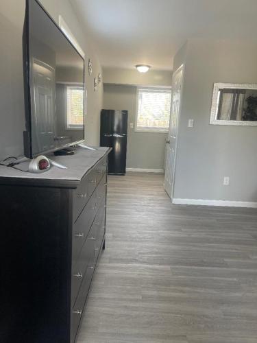 an empty room with a kitchen with a refrigerator at Point Pleasant Inn in Point Pleasant Beach