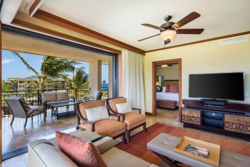 a living room with a flat screen tv and a couch at Koloa Landing Resort at Po'ipu, Autograph Collection in Koloa