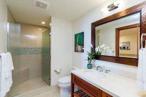 a bathroom with a toilet and a sink and a shower at Koloa Landing Resort at Po'ipu, Autograph Collection in Koloa