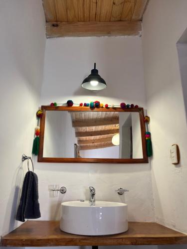 a bathroom with a sink and a mirror at LA MULITA HUMAHUACA in Humahuaca