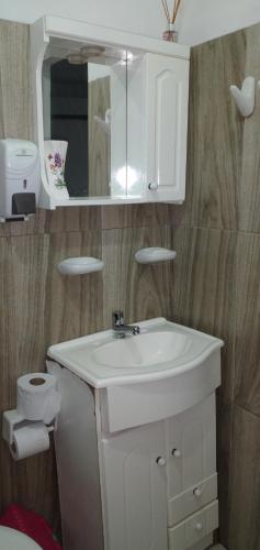 a bathroom with a white sink and a mirror at 3 cuadra polideportivo in San Vicente