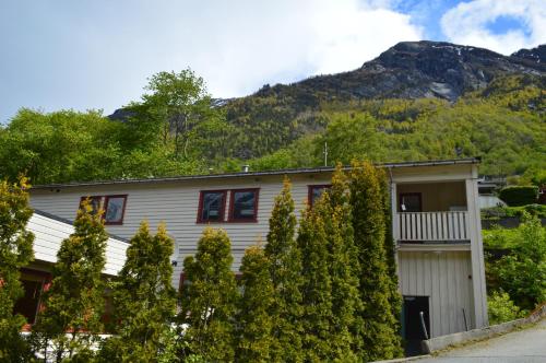 a house with trees in front of a mountain at Trolltunga Studios in Odda