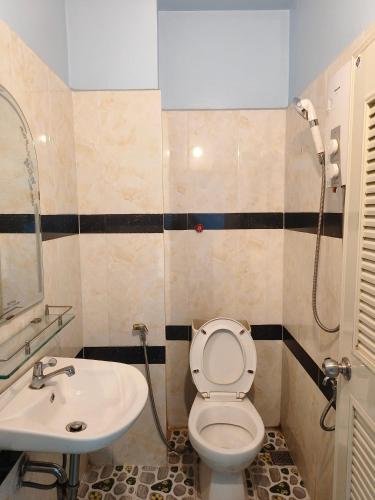 a bathroom with a toilet and a sink at Raksmey Kampuchea in Kampot