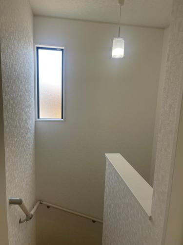 a white room with a window and a stair case at ゆうゆう八街新築4LDK free wifi in Yachimata