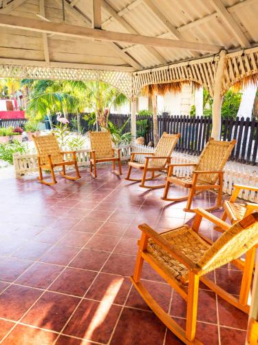 a group of chairs sitting on a patio at Utopia Guesthouse & Yoga Studio beachfront home in El Cuyo