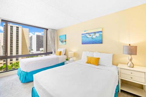 a bedroom with two beds and a large window at Diamond Head View at Waikiki Sunset with Parking in Honolulu