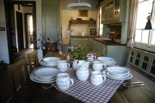 a table with blue and white dishes on it at Penzion Roubenka in Hukvaldy