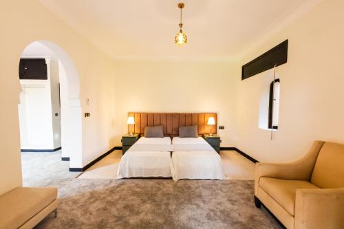 a hotel room with two beds and a couch at Villa Warhol Marrakech in Marrakech
