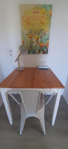a white table with a sign on top of it at Karuah Gardens Motel in Karuah