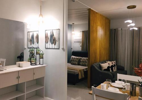 a living room with a dining table and a living room at Palawan Luxury Stay with Balcony, Free Gym & Pool - B1 5Topaz in Puerto Princesa City