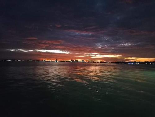 a sunset over a body of water at night at Apartamentos Don Mathias # 2 in Coveñas