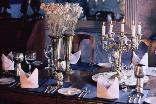 a table with napkins and candles on top of it at HELGASFOLLY Anti Hotel Residence in Kandy