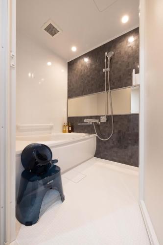 a bathroom with a shower and a toilet in it at Bell's Inn Tsuchiura in Tsuchiura