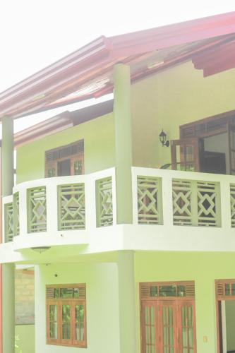 a house with a balcony on top of it at Urban Galle Villa in Galle