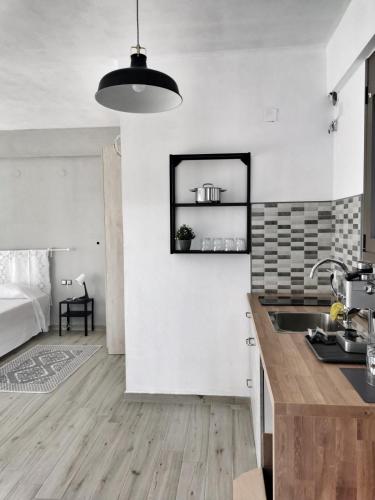 a kitchen with white walls and a sink in a room at Maurizio's Villa in Yiáltra