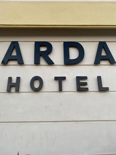 a sign on the side of a building at Hotel Arda Bali in Negara