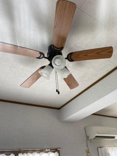 a ceiling fan on the ceiling of a room at Sun Sea GuestHouse in Yomitan