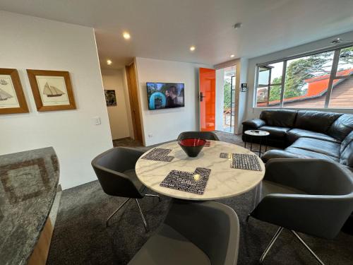 a living room with a table and a couch at Plymouth Central City 2 Bedroom Apartments in New Plymouth
