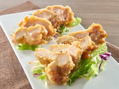a plate of food with chicken and lettuce on a table at Nagano Tokyu REI Hotel in Nagano