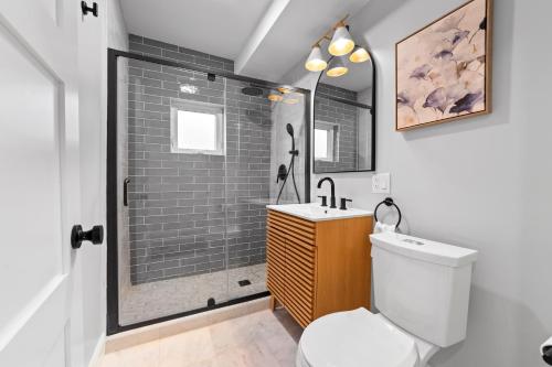 a bathroom with a shower and a toilet and a sink at Charming Room in Boston