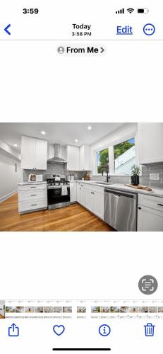 a white kitchen with white cabinets and appliances at Charming Room in Boston