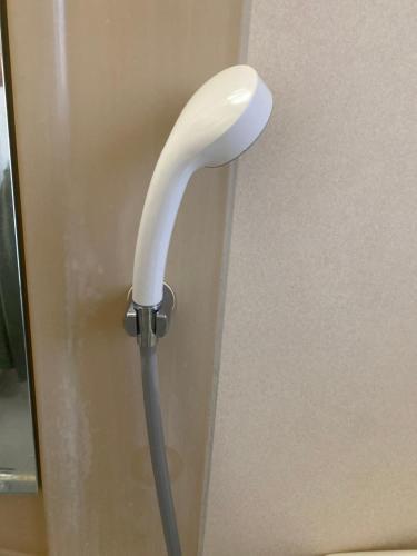 a white door handle sticking out of a door at Sun Sea GuestHouse in Yomitan