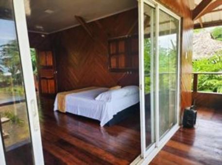 a bedroom with a bed and sliding glass doors at VILLA ENCANTO in El Valle