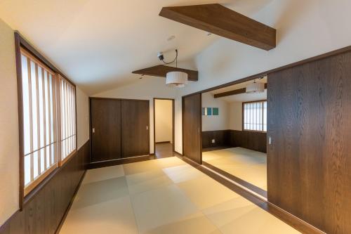 an empty hallway with wood paneling and windows at Irodori Hotel DAIDAI in Fukuoka