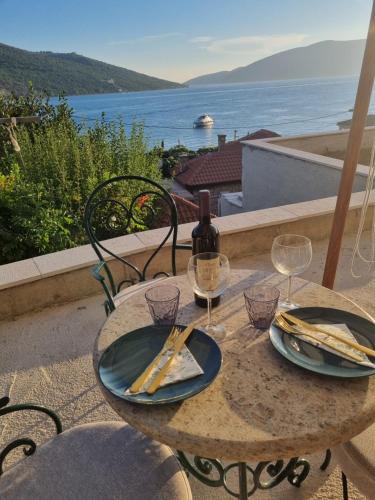 a table with two glasses and a bottle of wine at Kumbor, Herceg Novi in Kumbor